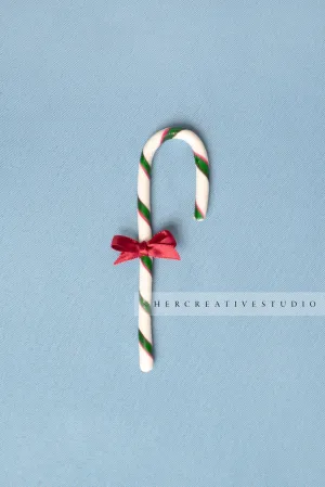 Candy Cane with Red Bow on Sky Blue Background