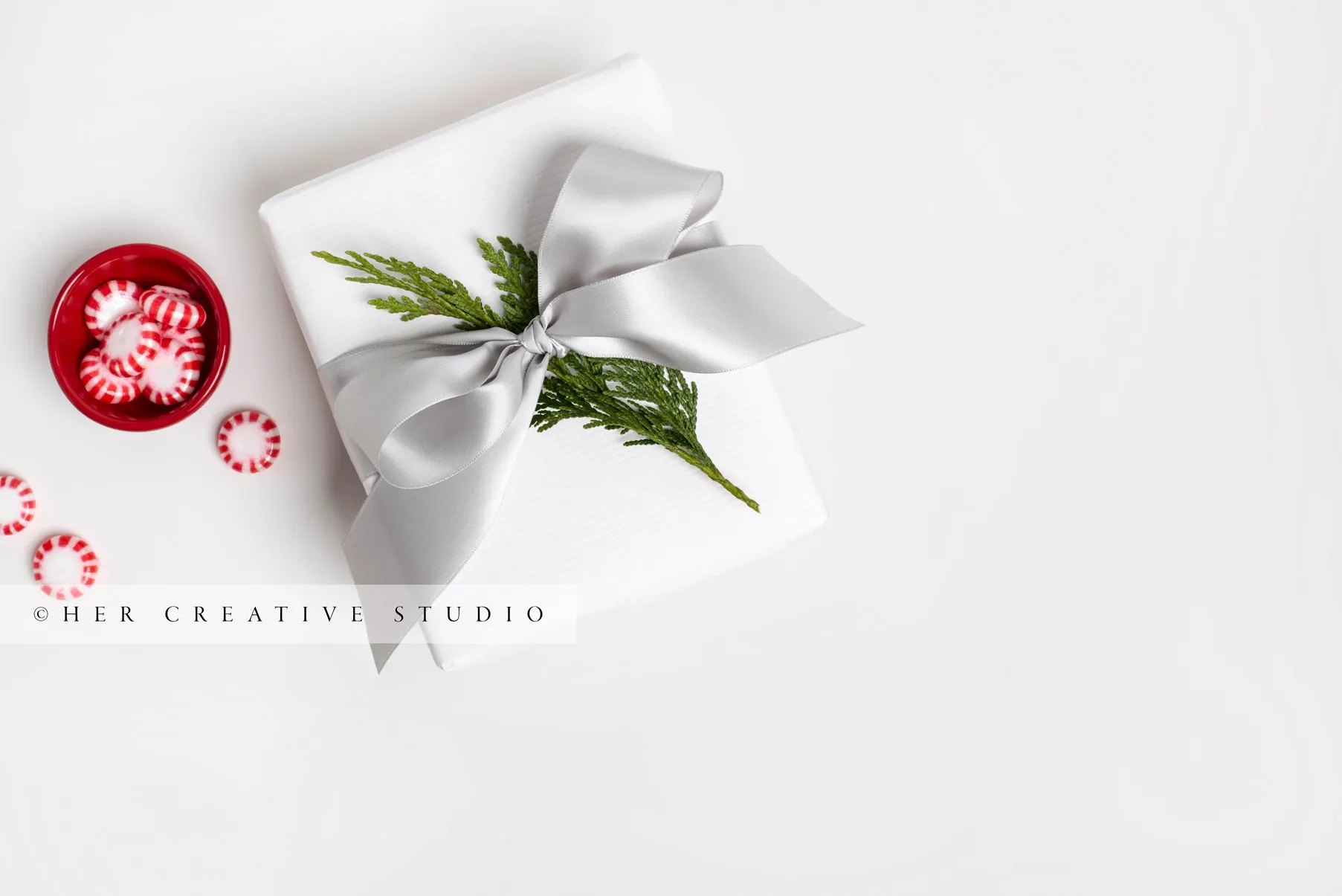 Holiday Gift With Grey Ribbon and Red Candy