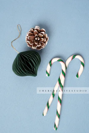 Holiday Ornaments & Pine Cone on Sky Blue Background