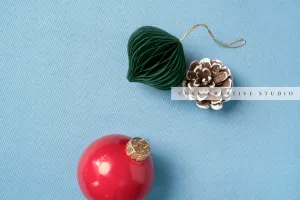 Red & Green Ornament on Sky Blue Background