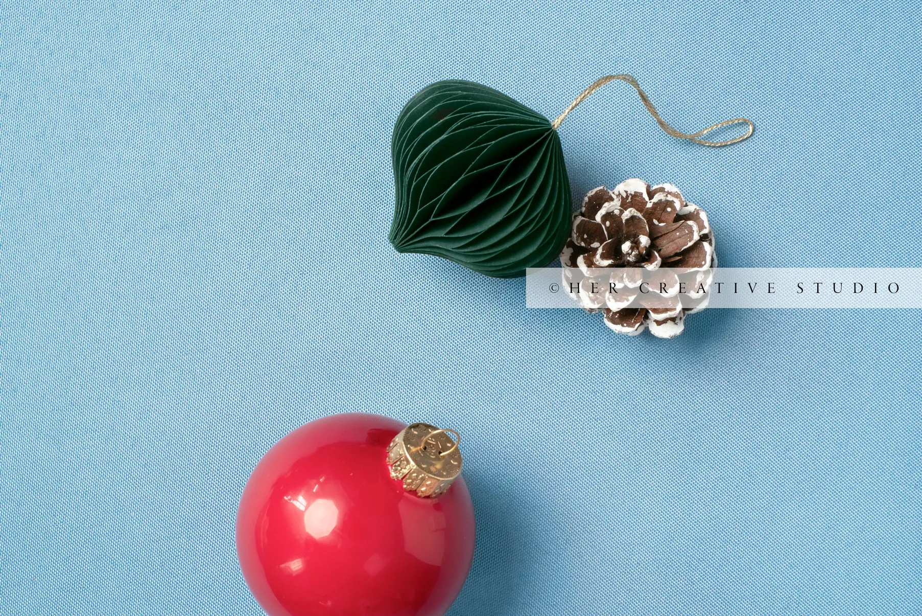 Red & Green Ornament on Sky Blue Background