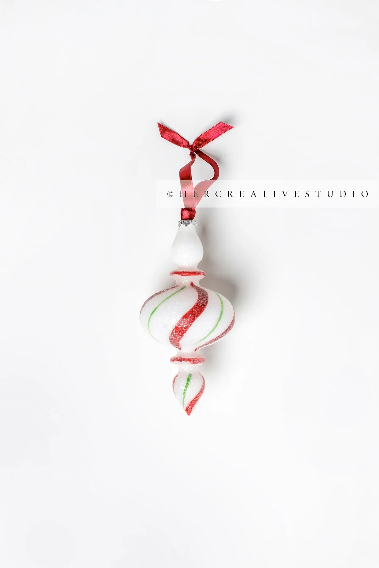 Red & Green Tree Ornament on White Background, Styled Image